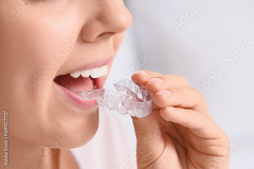 Young woman putting occlusa...