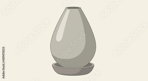 Modern grey teardrop-shaped ceramic vase with a smooth, glossy finish on a saucer.