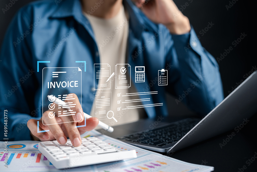 Fototapeta premium Digital invoice form and tax management concept. Businessman using calculator and laptop with billing e-invoicing, online accounting, and financial document processing.