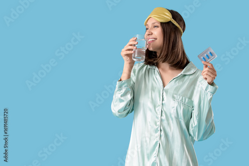 Young woman in pajamas with...