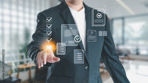 Fotografia A businessman in a suit touches a glowing digital checkbox on a virtual interface