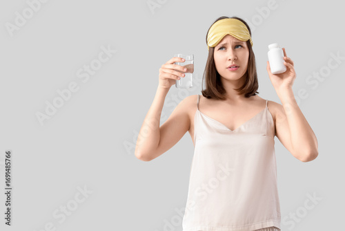 Young woman in pajamas with...