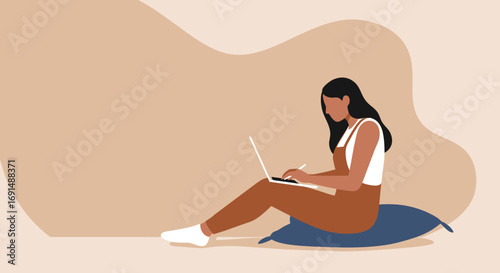 Focused woman working remotely on laptop with stylus, sitting on cushions. Represents flexible work, freelance, or online learning lifestyle.