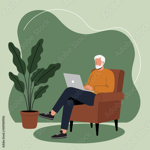 Senior man comfortably works on his laptop in a cozy armchair at home, embracing modern technology and remote work for a relaxed lifestyle.
