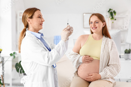 Female doctor vaccinating p...