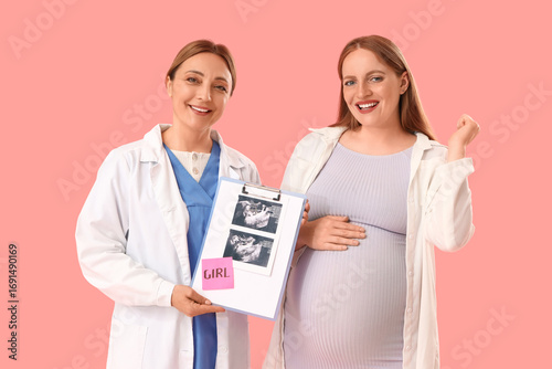 Happy pregnant woman and doctor with sonogram image of girl on pink background