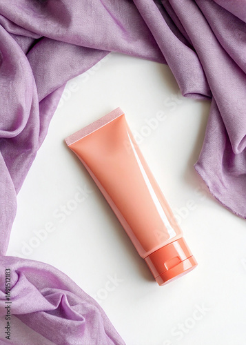 Peach Colored Skincare Tube with Lilac Fabric on White Background mockup