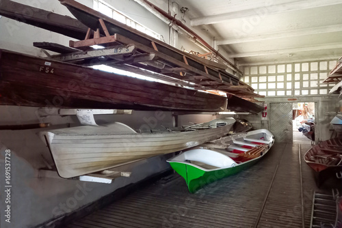 Canvas-taulu Interior of a hangar or boathouse of a rowing club or boatyard with boats on rac