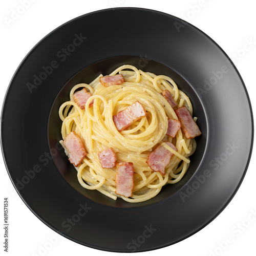 Carbonara pasta with crispy pancetta in a deep black bowl top view isolated on white background
