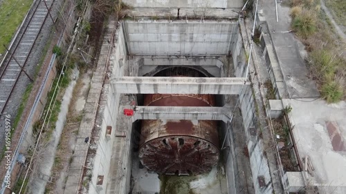 Dynamic aerial shots showing the lack of activity in the Sarmiento Railway tunnel boring machine pit in Villa Luro, Buenos Aires. The work is halted.