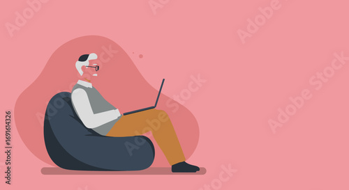Senior man relaxing on a bean bag chair, using a laptop. Represents comfortable remote work, digital learning, and modern senior lifestyle.