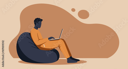 Relaxed person focused on their laptop while sitting comfortably on a beanbag chair. Ideal for remote work, education, or modern digital lifestyle concepts.