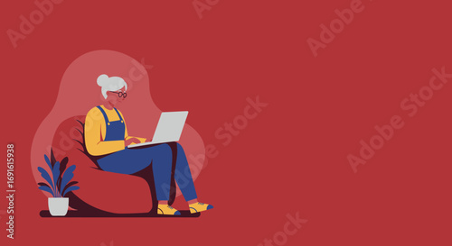 Elderly woman comfortably using a laptop on a bean bag, embracing technology at home. Ideal for digital literacy, remote work, and modern lifestyle concepts.