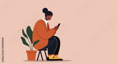 Focused woman in an orange sweater sits and uses her smartphone, embracing digital connection and communication in a relaxed setting with a plant.