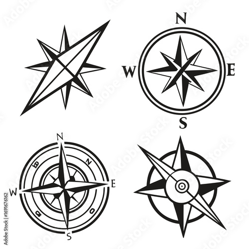 Collection of four black and white compass rose icons and wind rose symbols representing navigation and direction on a clean white background