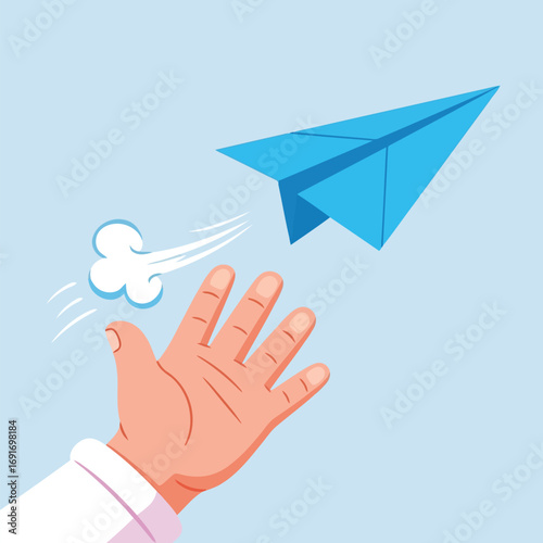Hand releasing a blue paper airplane into the air throwing launching