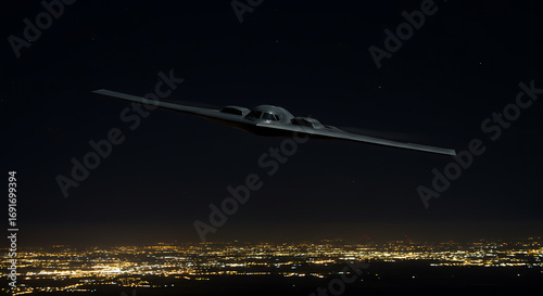 Night flight of a B-2 Spirit stealth bomber over city lights.