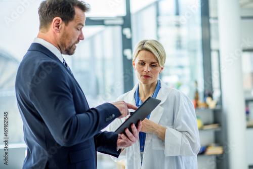 Photos Pharmaceutical sales representative introducing new medication to female doctor