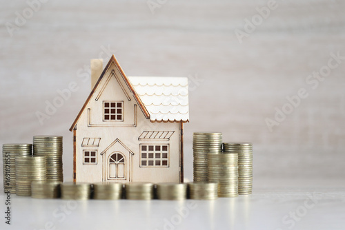 Photos Mortgage,Model house and stack of coins money on wooden background,Business inve
