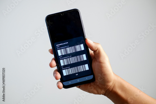 Detailed photo of IMEI code on mobile phone screen in hand isolated on white background.