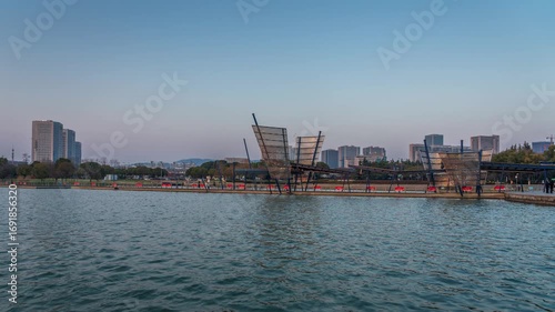 Tranquil Lakeside Scene with Modern Cityscape at Dusk  