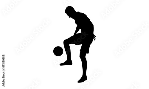 Black silhouette of a male soccer player practicing and juggling a football with his knee against a white background.