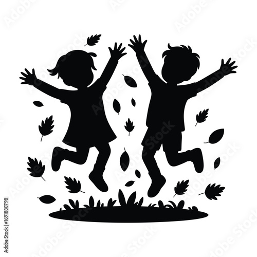Silhouette of two children jumping with autumn leaves and grass playing