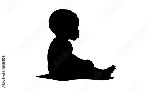 Silhouette of a seated baby, side view, on a blanket.