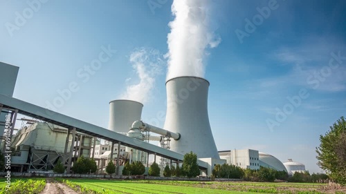 Captivating Nuclear Power Plant Surrounded by Lush Green Fields and Blue Sky  