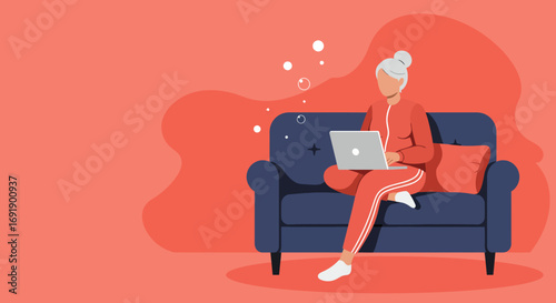 Senior woman in tracksuit using a laptop on a sofa at home, depicting remote work, online learning, or digital communication. Ideal for lifestyle and business concepts.