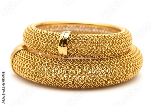 Two gold bangles with textured surface isolated on white background