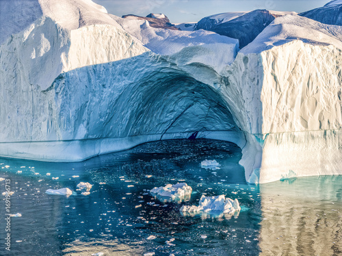 Ice cave in an ice floe. Greenland, unbelievable icy beauty in Qarajaq Isfjord