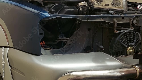 The mechanic is changing the car's headlights