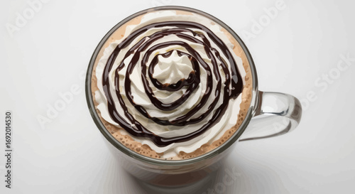 A glass mug of hot chocolate topped with whipped cream and chocolate swirls.