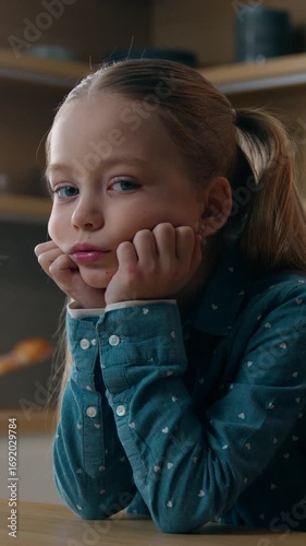 Family problem depressed despair melancholy sad little Caucasian child girl at kitchen boring stressed need parents help custody adoption upset bored daughter lonely kid stress at home sorrow sadness