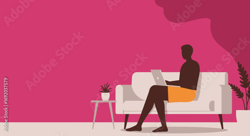 A man in casual attire works on a laptop from a comfortable sofa in a modern home, perfect for depicting remote work, digital nomad lifestyle, or online learning.