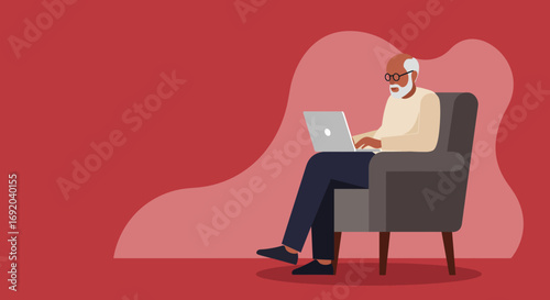 Senior man with white hair and beard wearing glasses, sitting comfortably in an armchair, typing on a laptop. Modern lifestyle and technology.
