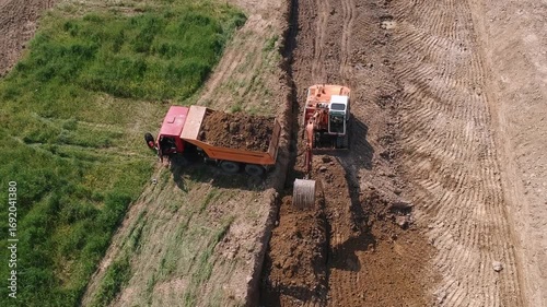 Excavator Loading Earth into a Dump Truck