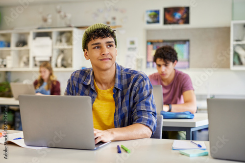 Wallpaper Mural Multiethnic guy daydreaming in classroom during lesson Torontodigital.ca