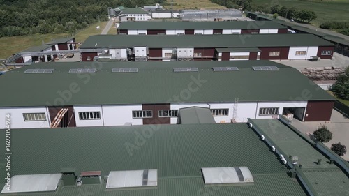 Aerial Footage of Modern Industrial Area with Green Roofs and Surrounding Roads