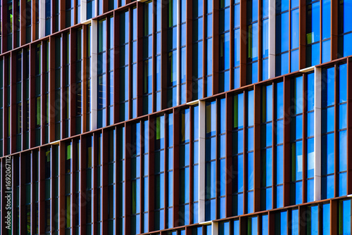 Wallpaper Mural Modern office façade with grid-like dark framing and reflective windows creating depth, order, and architectural rhythm. Torontodigital.ca