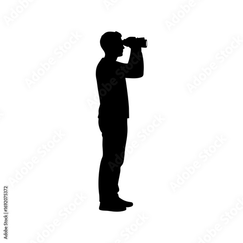 Silhouette of a boy using binocular