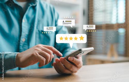 Foto Close-up of a person using a smartphone to leave a five-star review with digital rating icons, concept of customer satisfaction, feedback, online reputation and user experience