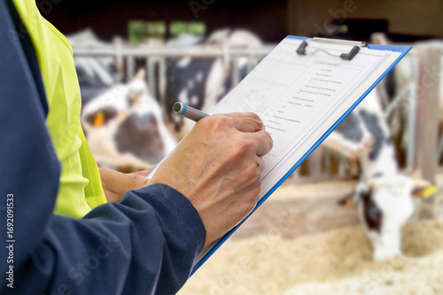 Hands, engineer and clipboard for checklist, inspection notes or safety compliance. Person,writing with documents for, inspecting cows at dairy farm or supervisor paperwork and pen