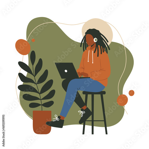 Person with dreadlocks works on a laptop, wearing headphones in a modern, casual setting. Represents remote work, online learning, digital lifestyle, and productivity.