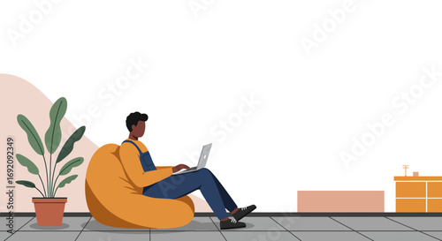 Relaxed man using a laptop on a bean bag chair in a modern, comfortable setting. Perfect for remote work, digital lifestyle, or online business.