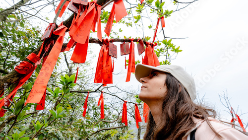Woman Observing Red Wish Ribbons on Tianmen Mountain Trail