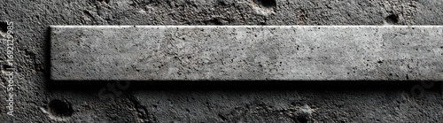 Gray rectangular slab on textured concrete