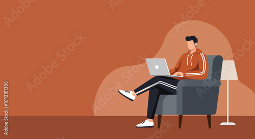 A man comfortably uses his laptop in an armchair, representing modern remote work, distance learning, or relaxed productivity at home.