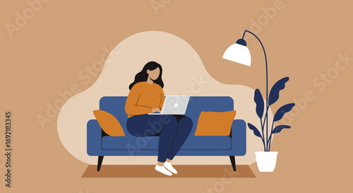 Woman working comfortably on her laptop from a blue sofa at home, showcasing remote work, online learning, or a relaxed lifestyle.